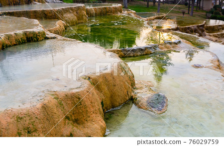 Travertine terraces with hot water of Karahyit Red Springs, Turkey Travertine terraces with hot water of Karahyit Red Springs, Turkey 76029759