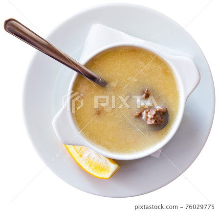 Turkish soup Paca corbasi served with lemon slice Turkish soup Paca corbasi served with lemon slice 76029775