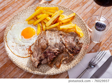 cuisine american roast pork with scrambled egg served on plate on table cuisine american roast pork with scrambled egg served on plate on table 76029937