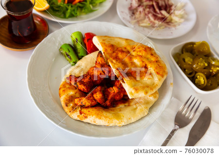 Traditional chicken kebab, tortillas and stewed vegetables Traditional chicken kebab, tortillas and stewed vegetables 76030078