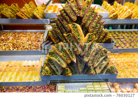 Honey baklava with nuts on display of Turkish sweetshop Honey baklava with nuts on display of Turkish sweetshop 76030127