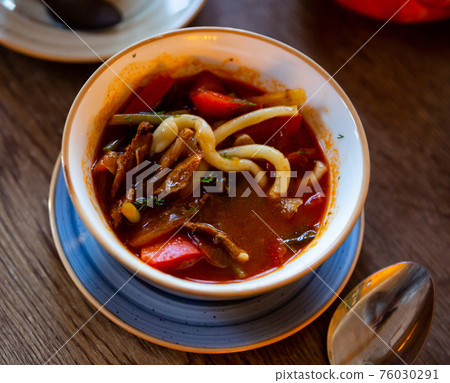 Portion of lagman, Central Asian dish of pulled noodles, meat Portion of lagman, Central Asian dish of pulled noodles, meat 76030291
