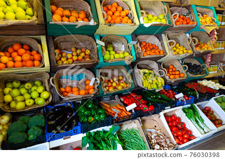 Raw fresh vegetables and fruits assortment on counter 76030398
