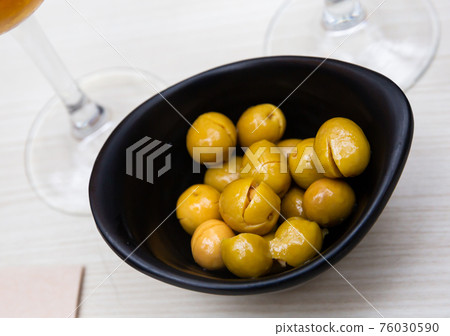 Pitted olives - typical Spanish snack Pitted olives - typical Spanish snack 76030590