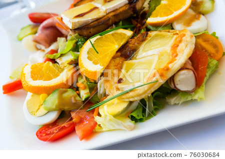 Salad with goat cheese, greens, vegetables Salad with goat cheese, greens, vegetables 76030684