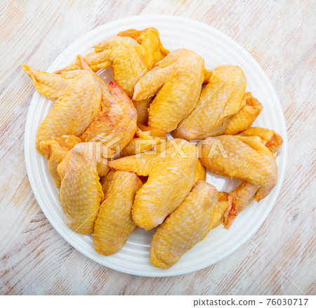 Farmer chicken wings on white plate Farmer chicken wings on white plate 76030717