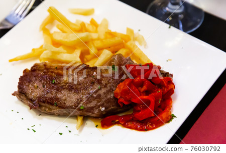 Steak entrecote of beef with fried potatoes and paprika Steak entrecote of beef with fried potatoes and paprika 76030792