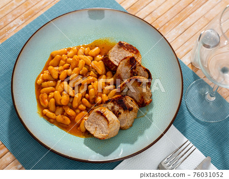 Delicious fried pork with beans in gravy on plate Delicious fried pork with beans in gravy on plate 76031052