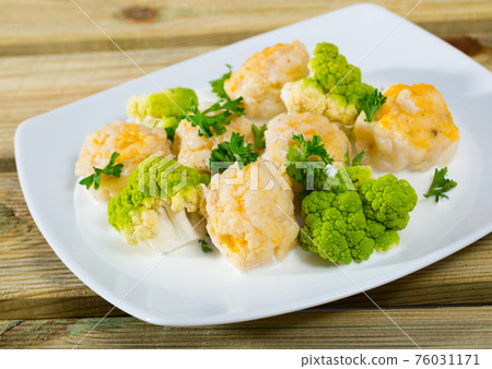 Norwegian cuisine fish balls with tasty white fish served with brokkoli at plate 76031171