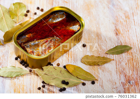 Open tin can of spicy sardines in aluminium can Open tin can of spicy sardines in aluminium can 76031362