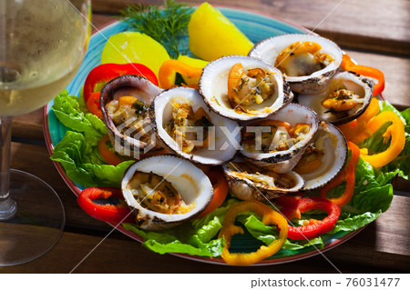 Baked European bittersweet with vegetables and white wine 76031477