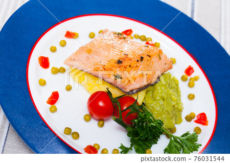 Deliciously fried trout fillet with mashed potatoes, guacamole and greens Deliciously fried trout fillet with mashed potatoes, guacamole and greens 76031544