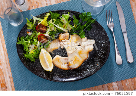 Dish of ocean fish tintorera (Prionace glauca) with lemon and herbs. 76031597