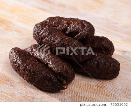Blood sausages on wooden table Blood sausages on wooden table 76031602