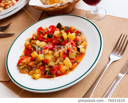 Plate of stewed vegetables on table. Vegetarian dish 76031610