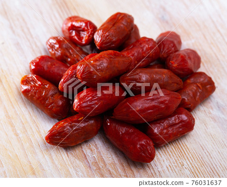Spanish Chistoritas sausages on a wooden surface 76031637