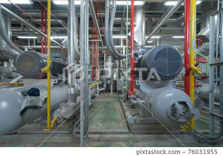 Inside of Industry factory. Chiller tower or cooling tower in building. System work machine. Condenser Water Supply and return pipe lines. Ventilation compressor. Water system in workshop. 76031955