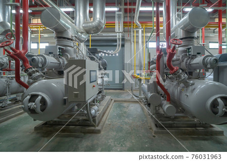 Inside of Industry factory. Chiller tower or cooling tower in building. System work machine. Condenser Water Supply and return pipe lines. Ventilation compressor. Water system in workshop. Inside of Industry factory. Chiller tower or cooling tower in building. System work machine. Condenser Water Supply and return pipe lines. Ventilation compressor. Water system in workshop. 76031963
