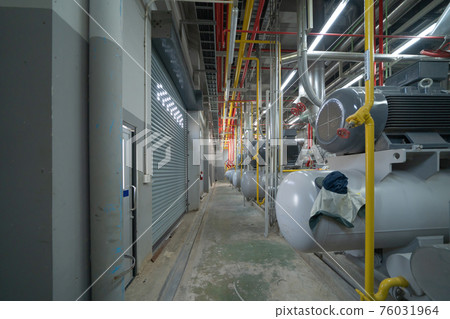 Inside of Industry factory. Chiller tower or cooling tower in building. System work machine. Condenser Water Supply and return pipe lines. Ventilation compressor. Water system in workshop. Inside of Industry factory. Chiller tower or cooling tower in building. System work machine. Condenser Water Supply and return pipe lines. Ventilation compressor. Water system in workshop. 76031964