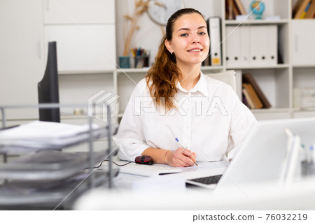 Portrait of young female office worker 76032219