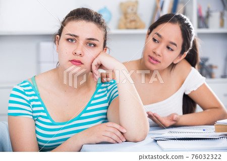 Girl asking for forgiveness from her friend 76032322