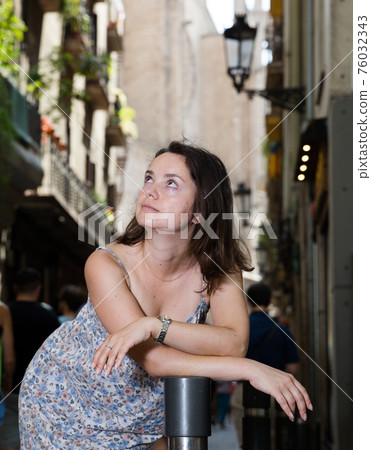 Girl walking in city streets Girl walking in city streets 76032343