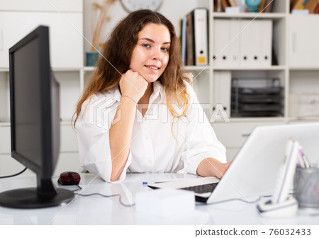 Portrait of young female office worker 76032433