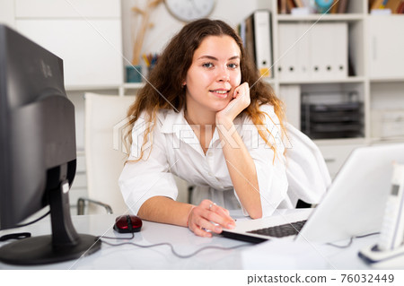 Portrait of young female office worker 76032449