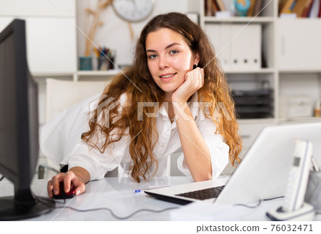 Portrait of young female office worker 76032471