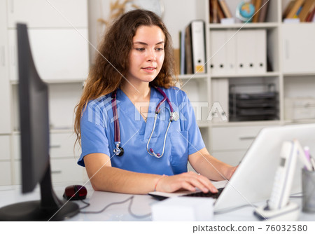 Woman therapist working with case histories at her workplace Woman therapist working with case histories at her workplace 76032580