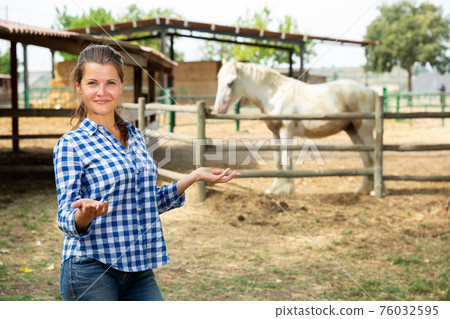 Owner of a horse farm shows her farm Owner of a horse farm shows her farm 76032595