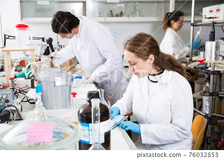 Female scientist taking notes in test chart Female scientist taking notes in test chart 76032853