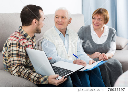 Aged couple signing agreement 76033197