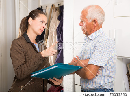 Businesswoman trying to collect arrearages from erderly man at home door 76033260