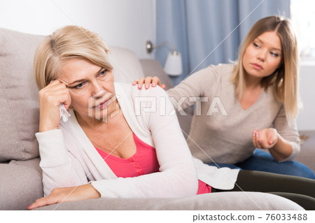 daughter comforts a sad mother daughter comforts a sad mother 76033488