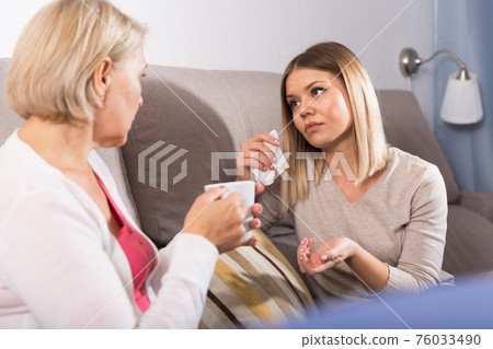 woman comforts her adult daughter woman comforts her adult daughter 76033490
