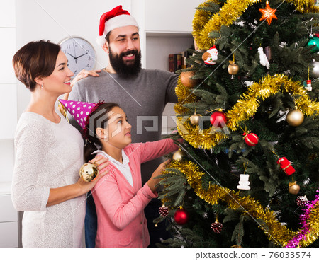 Family members preparing for Christmas Family members preparing for Christmas 76033574