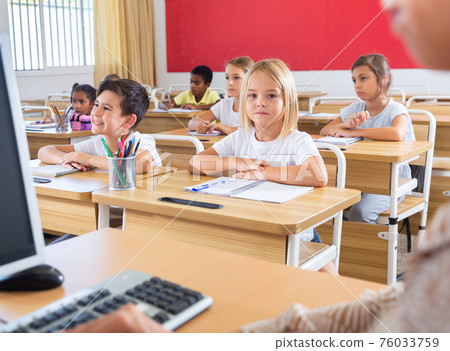 Group of focused children working at class Group of focused children working at class 76033759