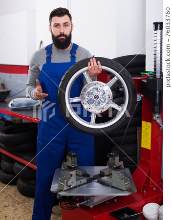 Worker repairing wheel Worker repairing wheel 76033760