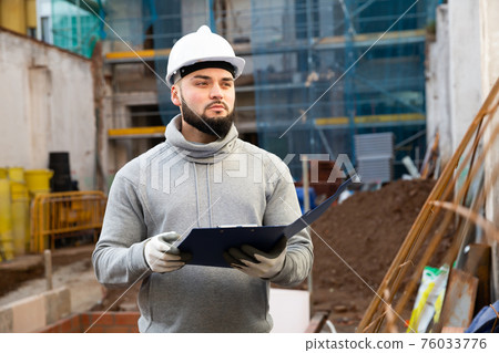 Foreman making task list during building works Foreman making task list during building works 76033776