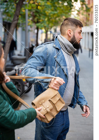 Guy snatching handbag of woman on street Guy snatching handbag of woman on street 76033835