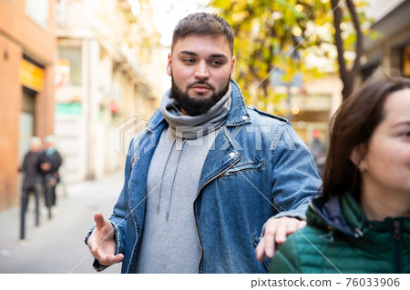 Man trying to pick up woman on street Man trying to pick up woman on street 76033906