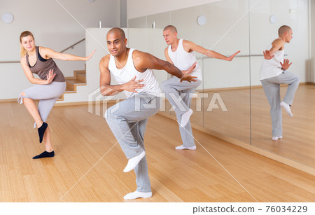 Man dancing at group lesson in studio 76034229