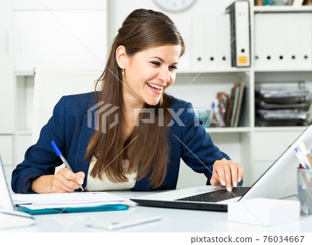 Successful adult business woman using laptop at workplace Successful adult business woman using laptop at workplace 76034667