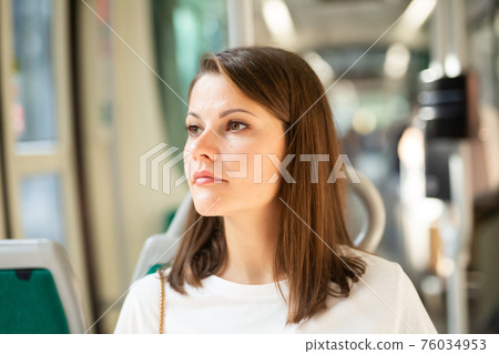 Woman traveling in modern streetcar 76034953
