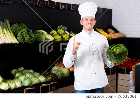 Man cook deciding on best vegetables Man cook deciding on best vegetables 76035061
