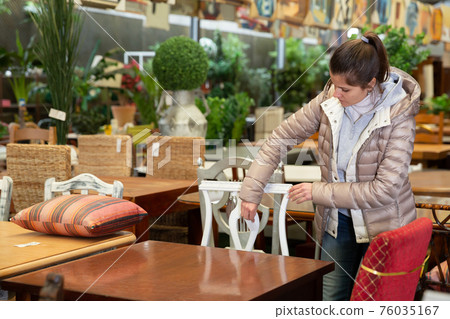 Woman choosing new furniture in salon 76035167
