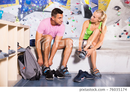 man and woman equipping for climbing workout 76035174