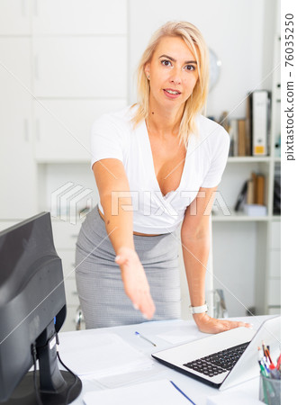 Businesswoman is going to meet visitors in her office 76035250