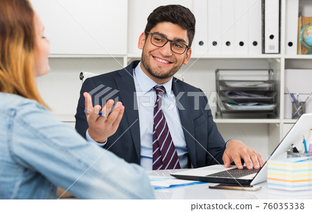 Businessman with female client Businessman with female client 76035338